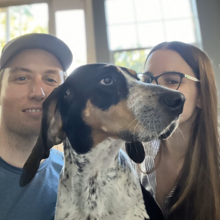 A portrait of Rob L'Heureux with his wife and dog.