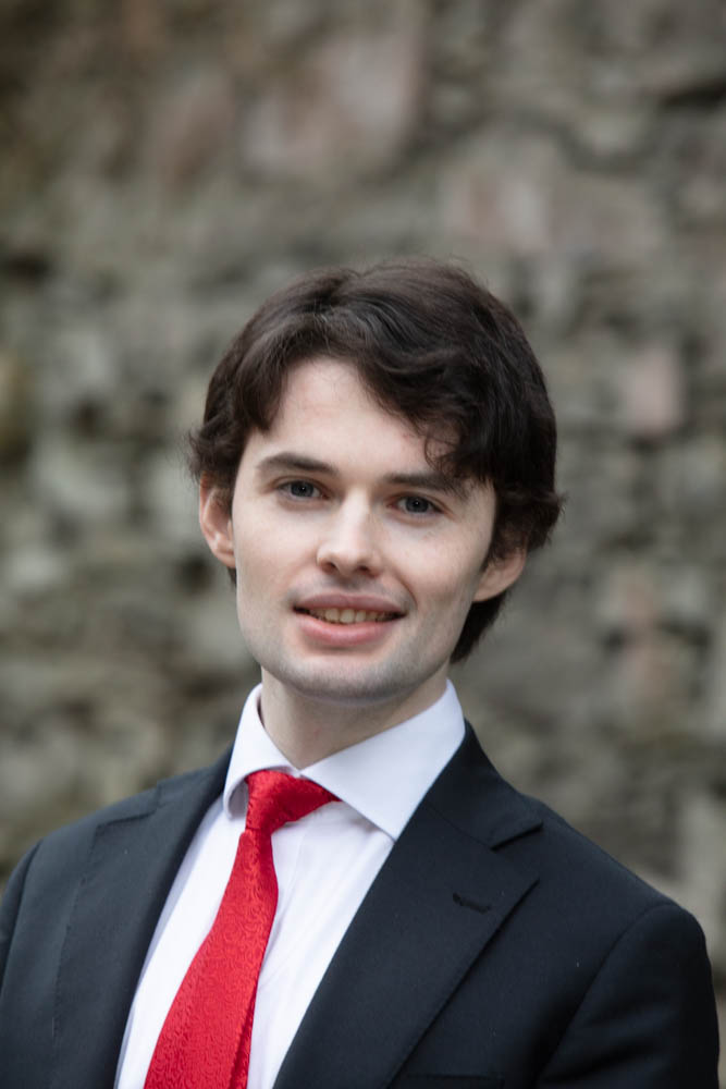 A professional headshot of writer Robert Long